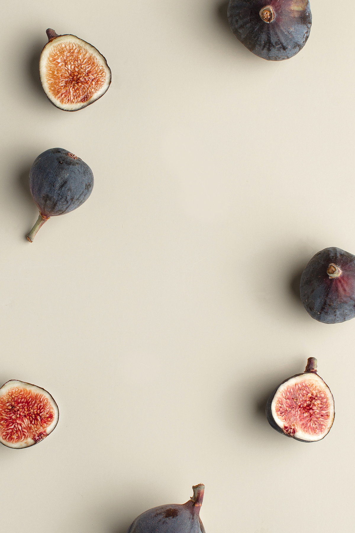 Fresh figs arranged on a light background